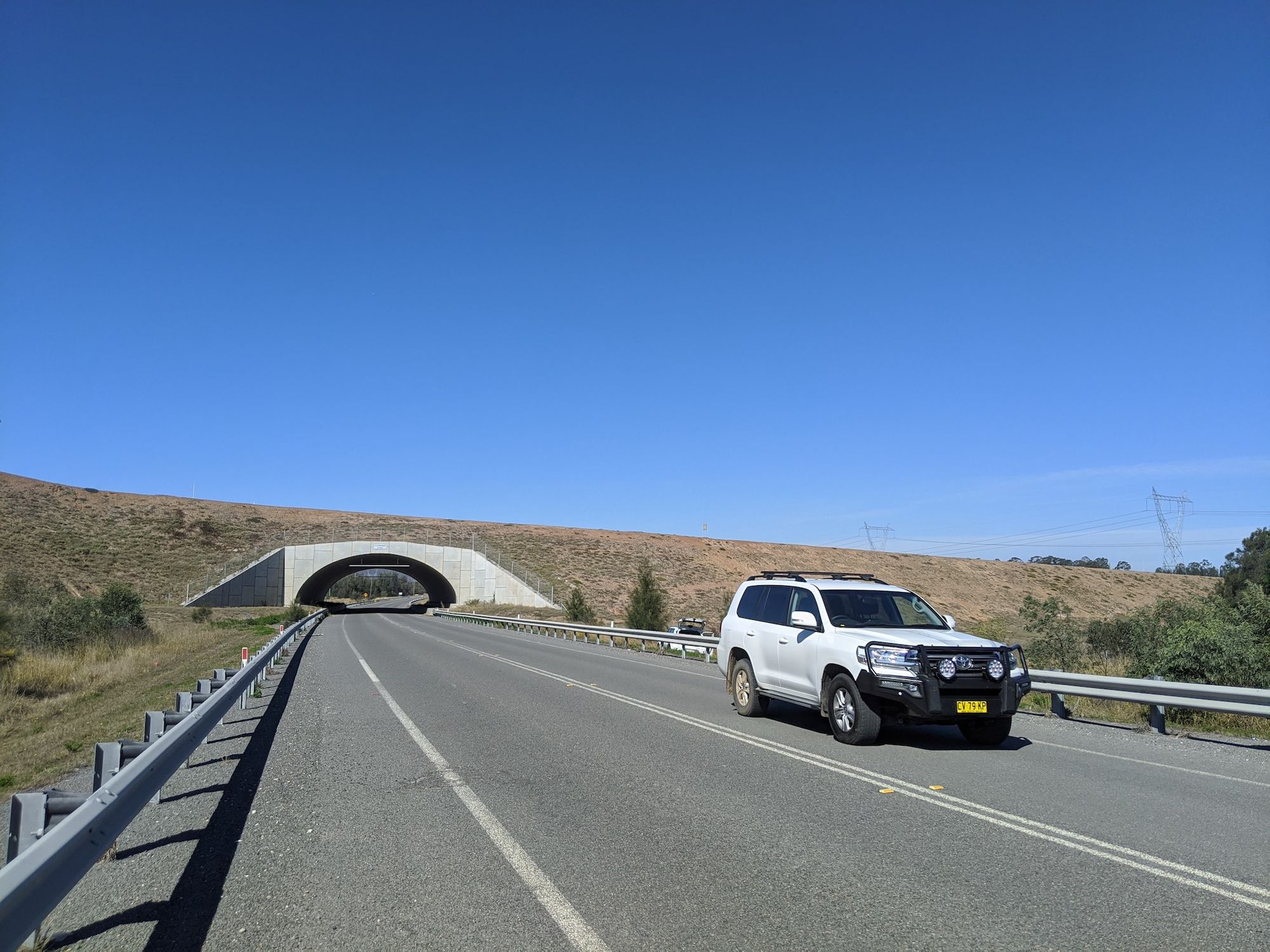 A tunnel under a bridge for mining trucks. The shoulder is about 2m wide.