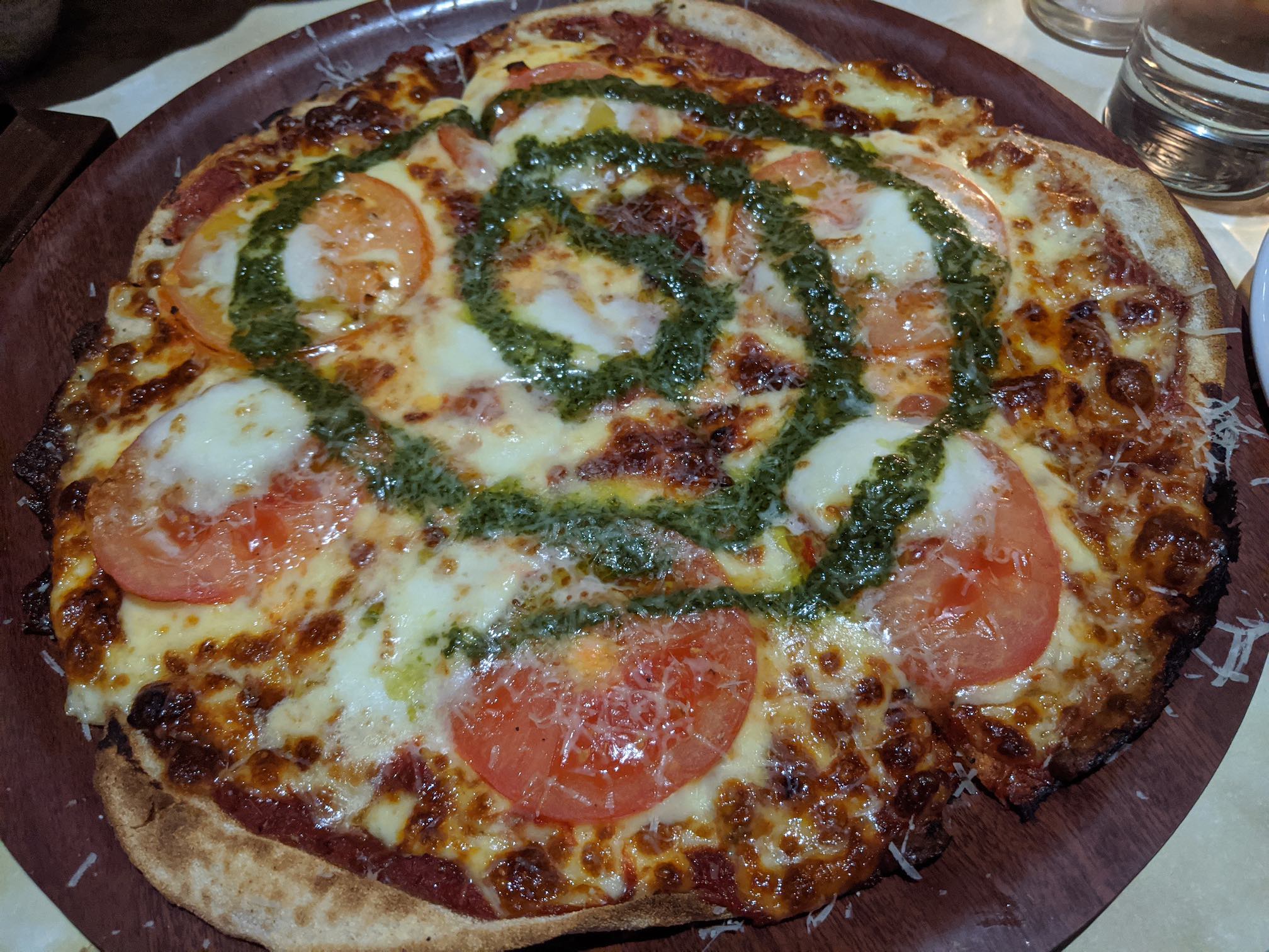 Margherita pizza, with cheese/tomatoes but a spiral of pesto instead of basil leaves.