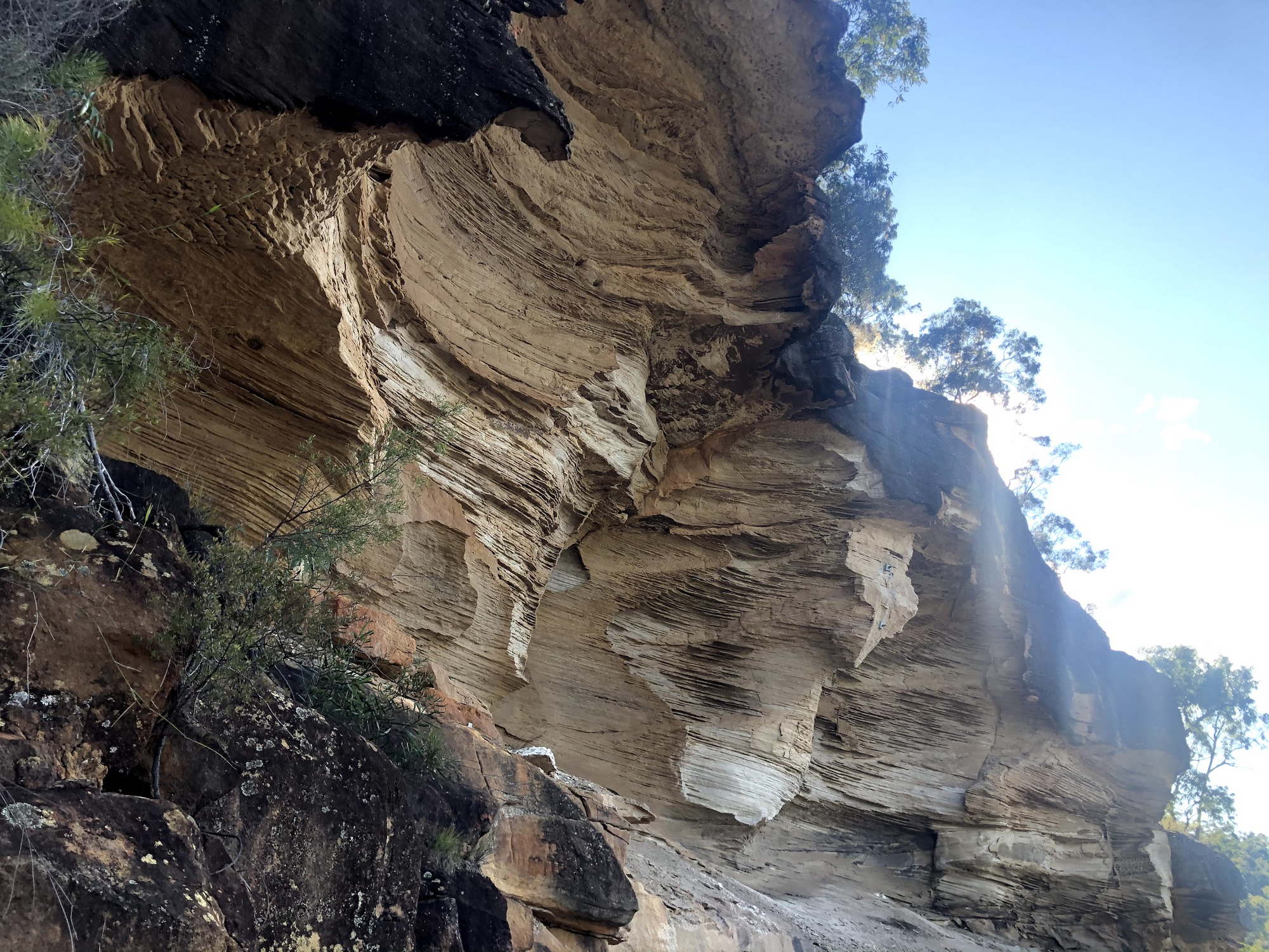 Sandstone half-arch cantilevered out over the road, precarious, maybe 20m high.