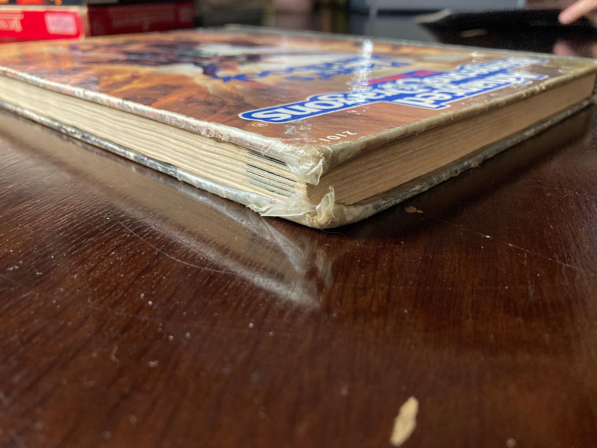 Corner of a book, the corner is raggedy and coversealed.