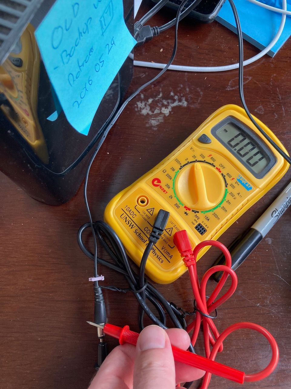 multimeter showing 0.00V connected to power supply