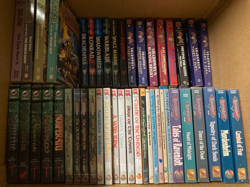 Moving box full of about 100 Dungeons & Dragons fantasy novels, stacked two deep